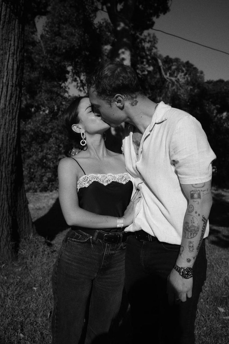 Black and white photo of a couple embracing outdoors.